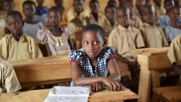 This photo taken on March 7, 2016 shows pupils in a classroom of the first elementary school built in 2013 by Swiss group Nestle, in the village of Goboue, in the southwest of Ivory Coast. 
"At five years old, I went to work in the fields with my dad. Today, my children go to school," said Peter, a cocoa farmer in Bonikro in the centre of Ivory Coast. Peter is one of a generation of farmers at the heart of a drive to keep the country's children in school and away from its vast plantations. / AFP / ISSOUF SANOGO        (Photo credit should read ISSOUF SANOGO/AFP/Getty Images)