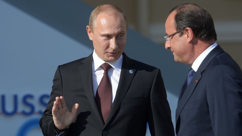 In this handout image provided by Host Photo Agency, Russian President Vladimir Putin stands with French President  Francois Hollande during an official welcome of G20 heads of state and government, heads of invited states and international organizations at the G20 summit on September 5, 2013 in St. Petersburg, Russia.  The G20 summit is expected to be dominated by the issue of military action in Syria while issues surrounding the global economy, including tax avoidance by multinationals, will also be discussed duing the two-day summit.