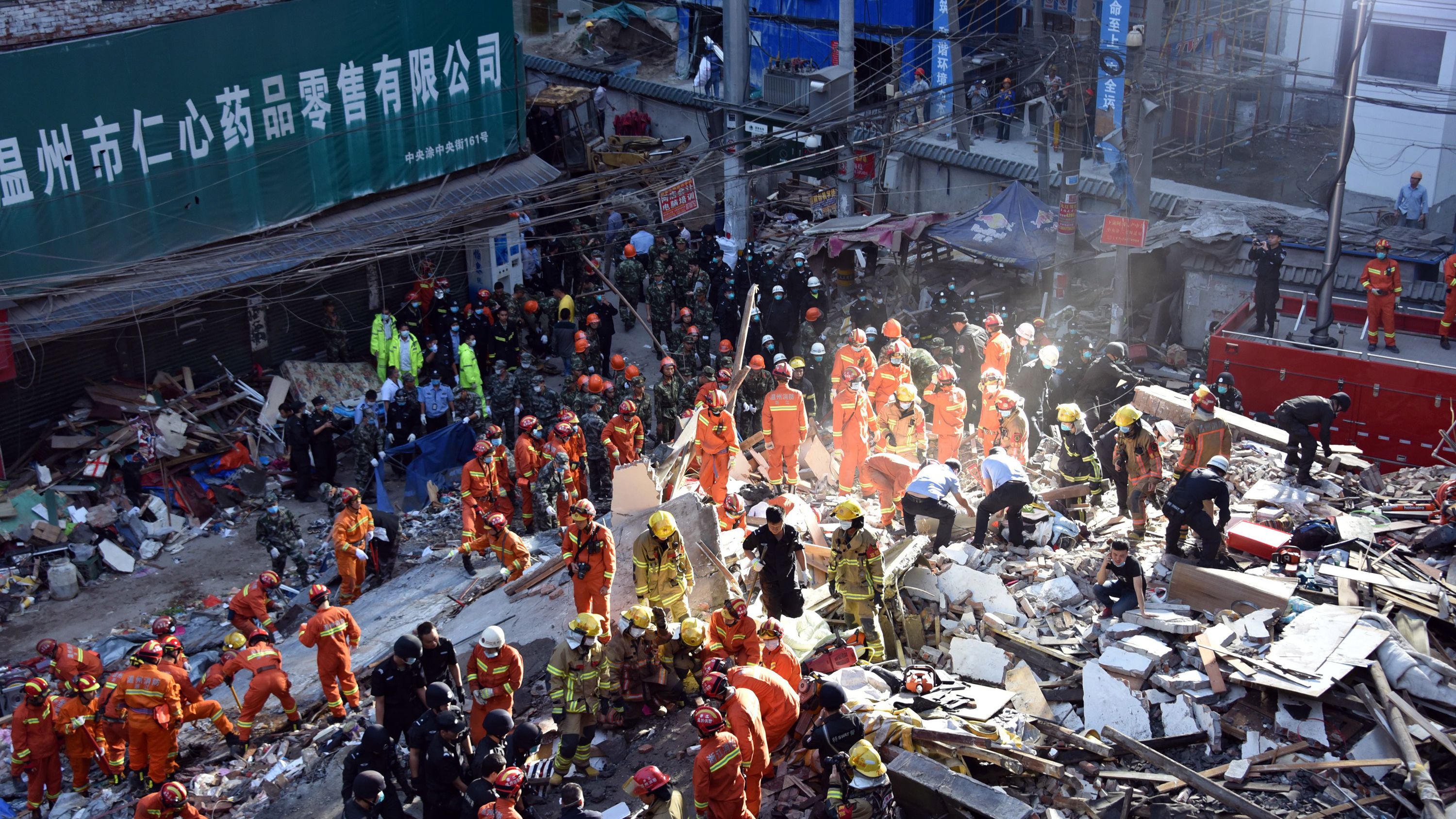 Rescuers search for survivors at an accident site after four buildings caved in during the early hours in Wenzhou, eastern China's Zhejiang province on October 10.