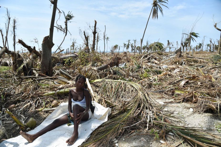 A woman sits in debris where her house once stood in Les Cayes on October 10.