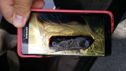 This Friday, Oct. 7, 2016, photo provided by Andrew Zuis, of Farmington, Minn., shows the replacement Samsung Galaxy Note 7 phone belonging to his 13-year-old daughter Abby, that melted in her hand earlier in the day. "She's done with Note 7s right now," Zuis said of his daughter. Reports of more replacement phones catching fire are trickling in, and the South Korean tech giant faces more scrutiny after earlier criticism for being slow to react and sending confusing signals in the first days of the recall. (Andrew Zuis via AP)