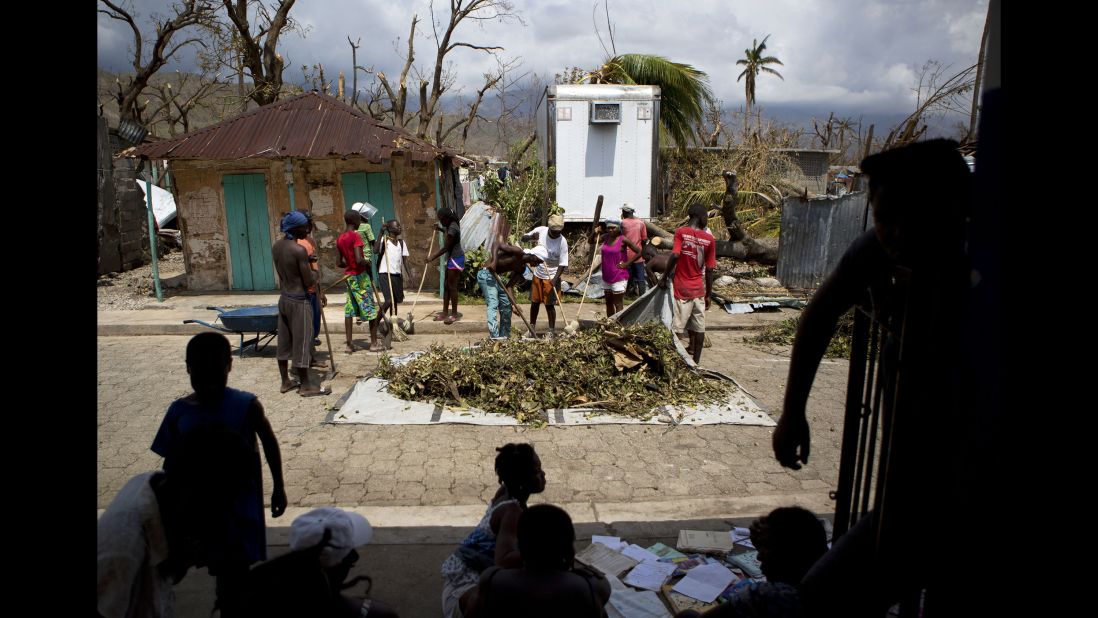 A group works to clear debris from the streets in Les Anglais on October 10.