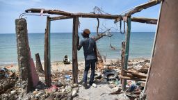 TOPSHOT - A man stands next to a destroyed house in Les Cayes, Haiti on October 10, 2016, following the passage of Hurricane Matthew. 
Haiti faces a humanitarian crisis that requires a "massive response" from the international community, the United Nations chief said , with at least 1.4 million people needing emergency aid following last week's battering by Hurricane Matthew. / AFP / HECTOR RETAMAL        (Photo credit should read HECTOR RETAMAL/AFP/Getty Images)