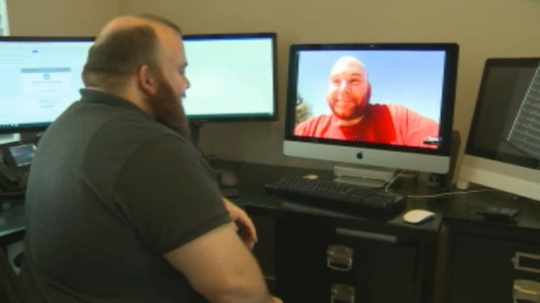 Craig Williams, left, talks with his brother Chris Williams, on monitor.
