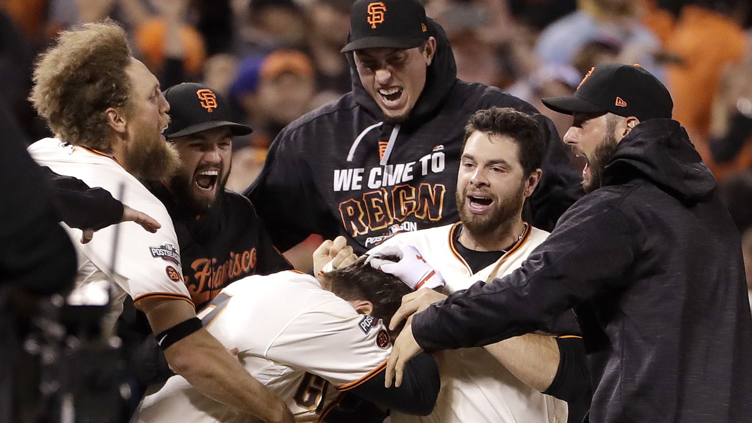 The San Francisco Giants celebrate an extra-inning win against the Chicago Cubs in Game 3 of the NDLS Monday.