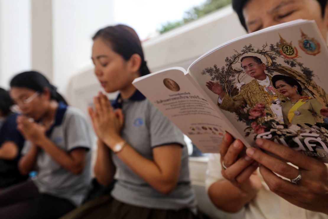 People pray during special prayers for Thai King Bhumibol Adulyadej at Wat Pathumwanaram temple on Monday, October 10, 2016 in Bangkok.