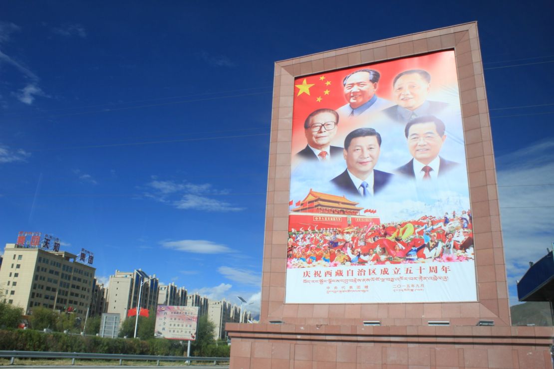 A poster  featuring the headshots of the previous five leaders of China greets visitors outside Lhasa airport.  This same grouping of photos is seen throughout Tibet.