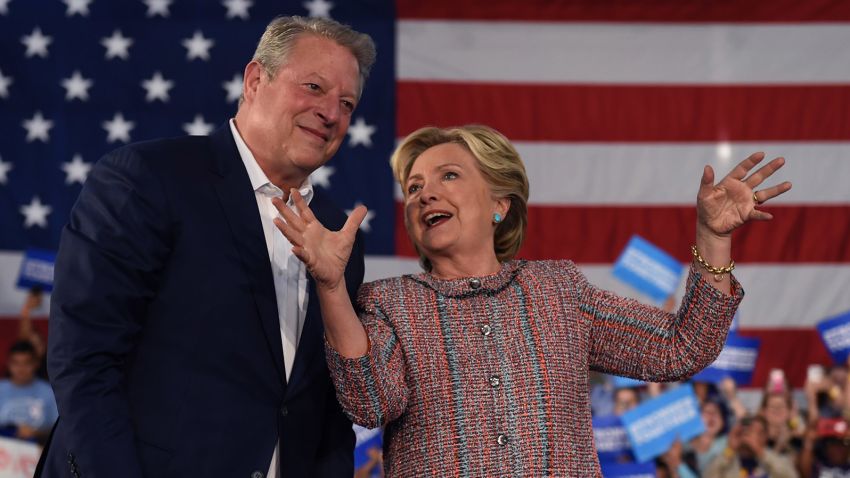 Former Vice President Al Gore (L) speaks with Democratic presidential nominee Hillary Clinton during a climate change event at Miami Dade College-Kendall Campus in Miami, Florida October 11, 2016.  
