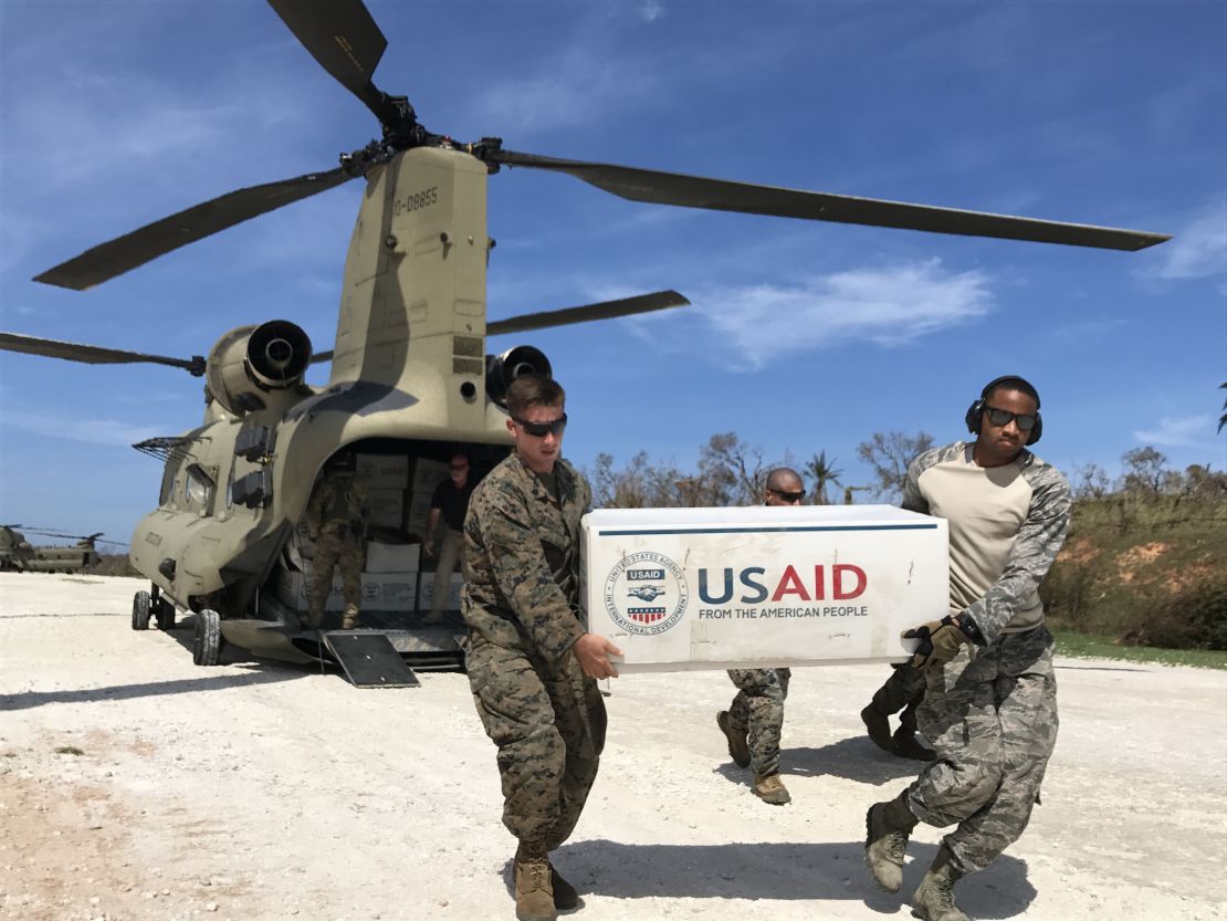 US troops unload plastic tarps for emergency shelters and rice from two US Army Chinooks at the landing strip outside the hurricane-stricken town of Jeremie.  