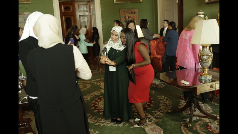 CNN's Isha Sesay, seen here in red taking a photo in the White House's Green Room, also traveled to Liberia and Morocco with Obama and <a href="index.php?page=&url=http%3A%2F%2Fwww.cnn.com%2F2016%2F10%2F10%2Fopinions%2Fcnn-films-we-will-rise-freida-pinto%2Findex.html" target="_blank">actress Freida Pinto</a>. 