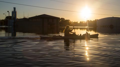 Buckley Miller paddles a canoe past a flooded water treatment plant in downtown Lumberton.