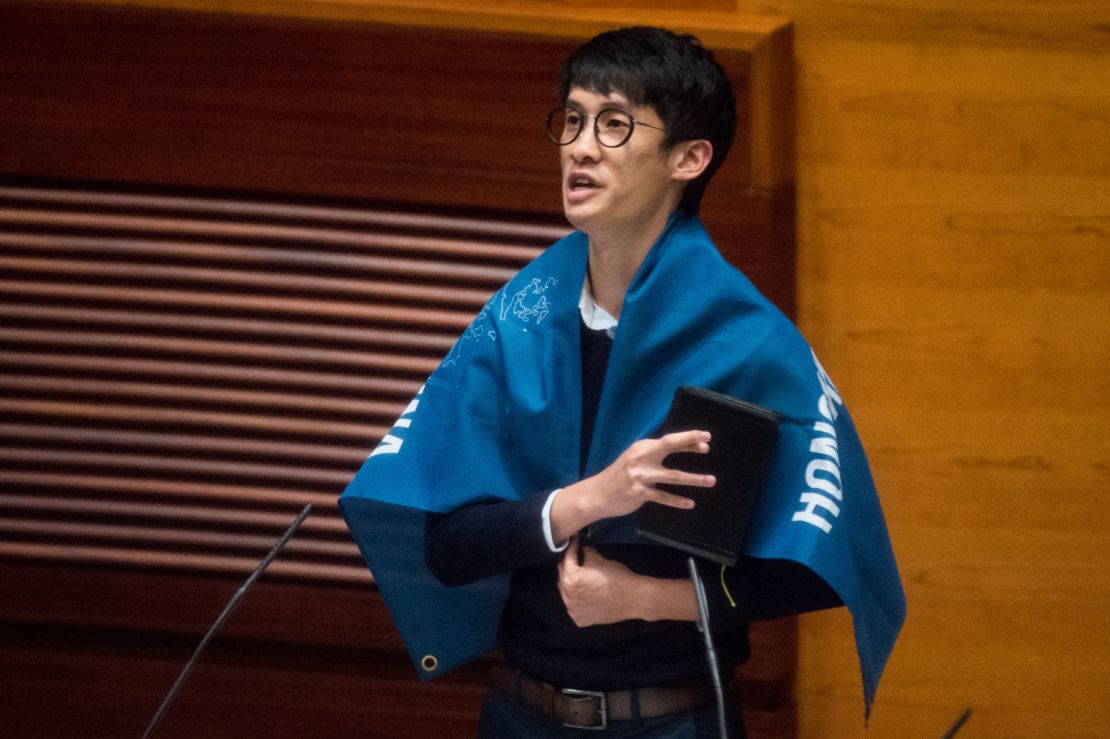 Baggio Leung wears a flag reading "Hong Kong is not China" during his oath-taking ceremony