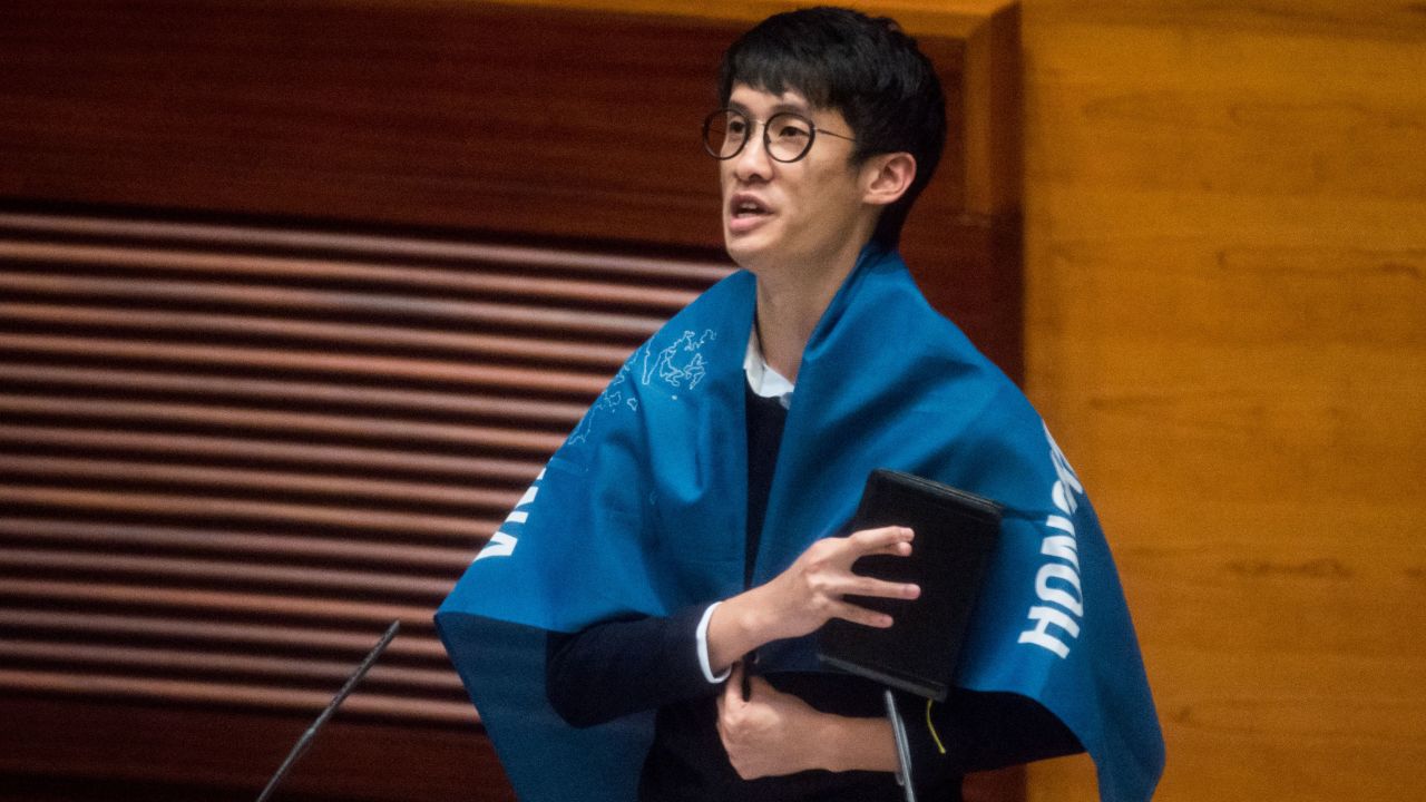 Baggio Leung wears a flag reading "Hong Kong is not China" during his oath-taking ceremony