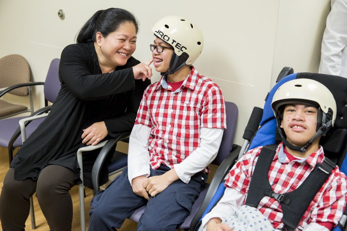 Arlene Aguirre waits with her twin sons Clarence, left, 14, and Carl, right, 14, at Dr. James T. Goodrich's office at The Children's Hospital at Montefiore. Dr. Goodrich separated the conjoined twins in 2004.