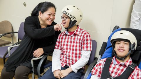 Arlene Aguirre waits with her twin sons Clarence, left, 14, and Carl, right, 14, at Dr. James T. Goodrich's office at The Children's Hospital at Montefiore. Dr. Goodrich separated the conjoined twins in 2004.