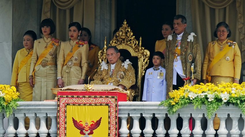 Thai King Bhumibol Adulyadej (C) is surrounded by his daughters Princesses Ubol Ratana (2nd L), Chulabhorn (3rd L), Sirindhorn (R), his son Prince Maha Vajiralongkorn (2nd R) and his grand-son Dipangkorn Rasmijoti (3rd R) as he sits on the throne after he delivered an address from a balcony of the Anantasamakom Throne Hall in front of the Royal Plaza in Bangkok's historic district on December 5, 2012. Thailand's revered king called for unity and stability in the divided nation on December 5 as huge crowds of adoring, flag-waving citizens packed Bangkok for a rare speech to mark his 85th birthday.   AFP PHOTO/Christophe ARCHAMBAULT / AFP / CHRISTOPHE ARCHAMBAULT        (Photo credit should read CHRISTOPHE ARCHAMBAULT/AFP/Getty Images)