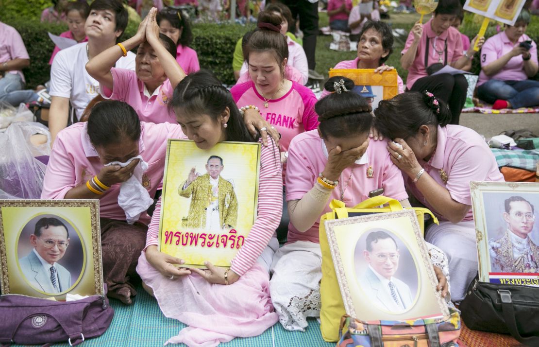 Thai people cry as they prayed for Thailand's King Bhumibol Adulyadej at Siriraj Hospital where the king was being treated in Bangkok, Thailand.