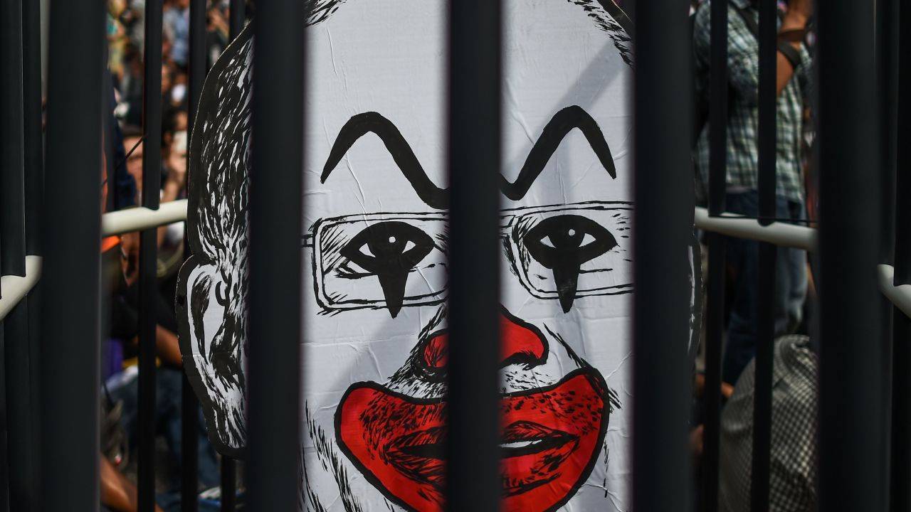 A student activist holds up a clown-faced caricature of Malaysian Prime Minister Najib Razak (Mohd Rasfan/AFP/Getty Images)