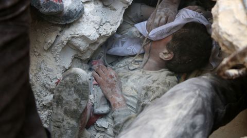 Jameel Mustafa Habboush, 13, receives oxygen as he is pulled from rubble caused by airstrikes.