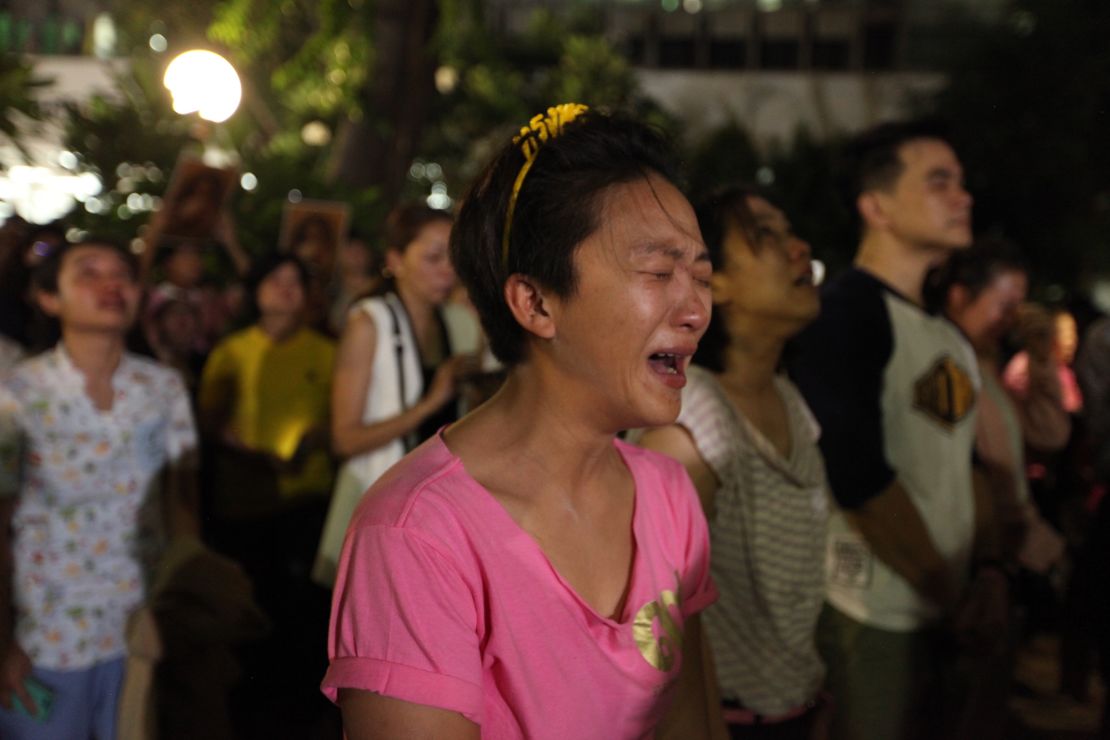 A Thai woman cries upon hearing that the nation's monarch had died.