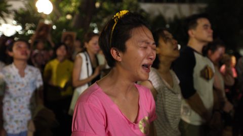 A Thai woman cries upon hearing that the nation's monarch had died.