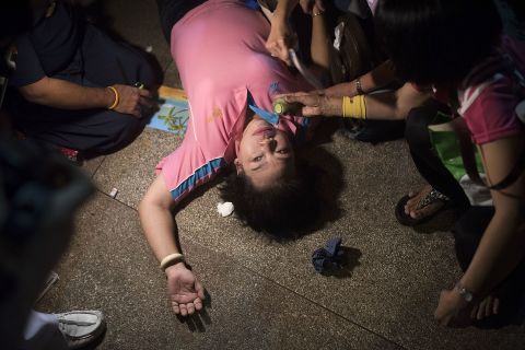 A woman passes out after an official statement announces the death of the king.