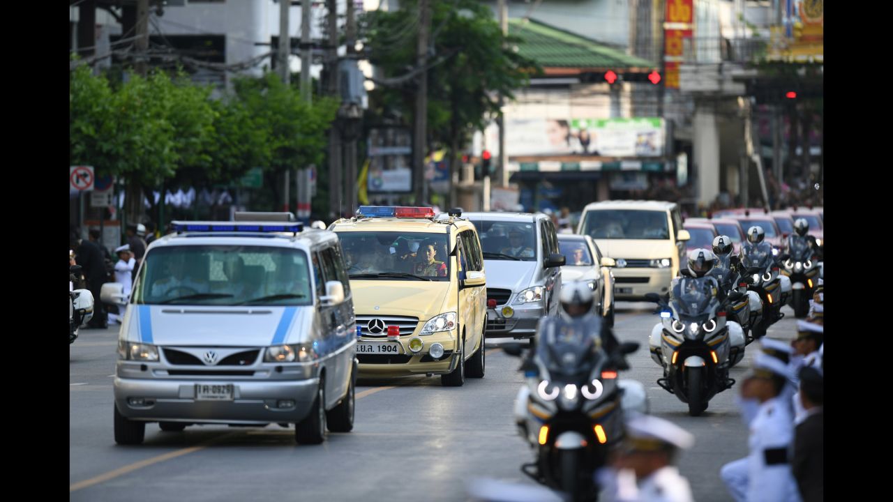 Amid a procession of vehicles, a van carries the body of the King to his palace in Bangkok on Friday.