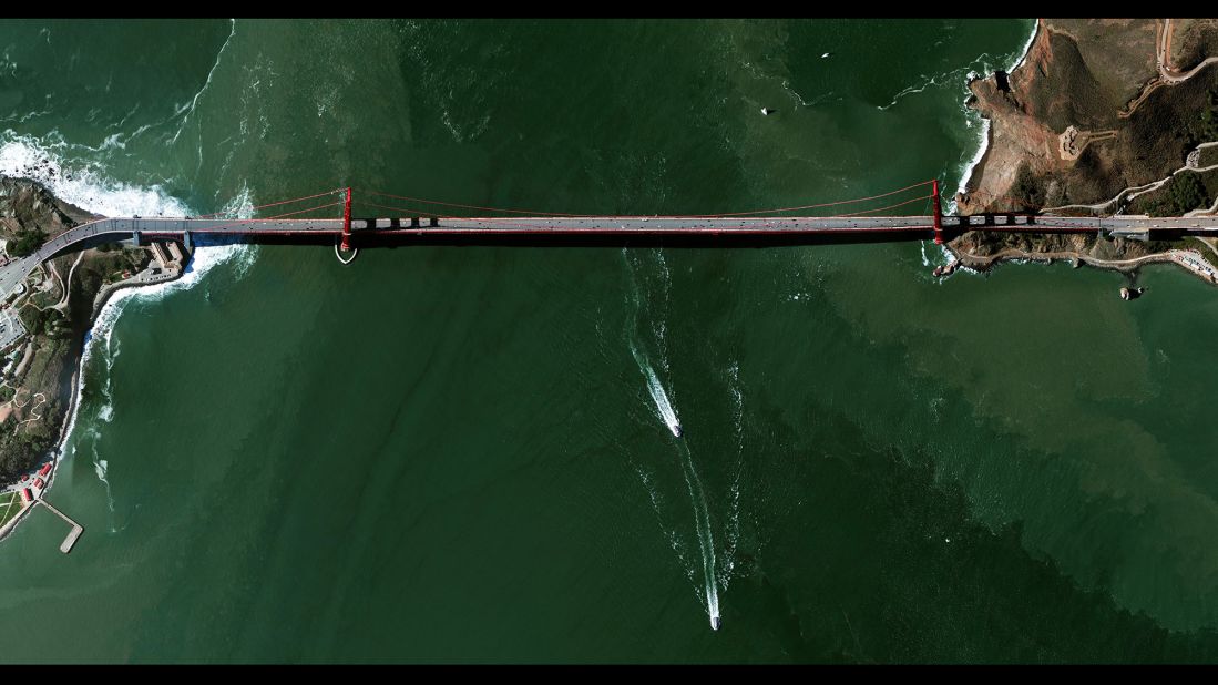 The Golden Gate Bridge is a 1.7-mile-long suspension bridge in San Francisco. The bridge's signature color, known as "international orange," was selected to complement its natural surroundings and enhances its visibility in fog. Grant makes images like this one by stitching together various tiles of satellite imagery.