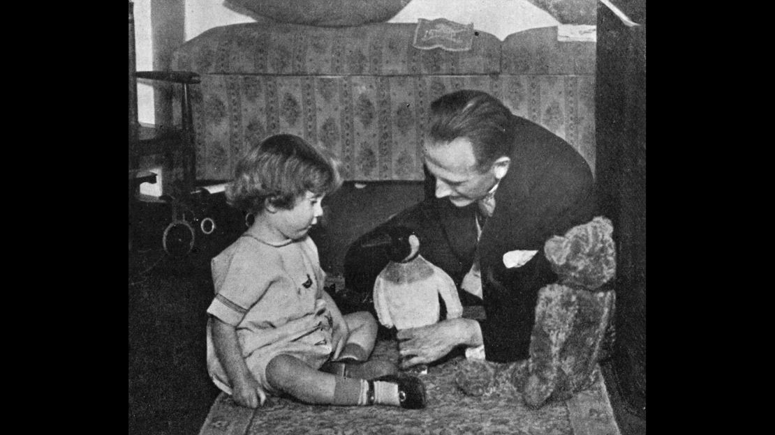A.A. Milne and son playing with the toy that inspired the new character.