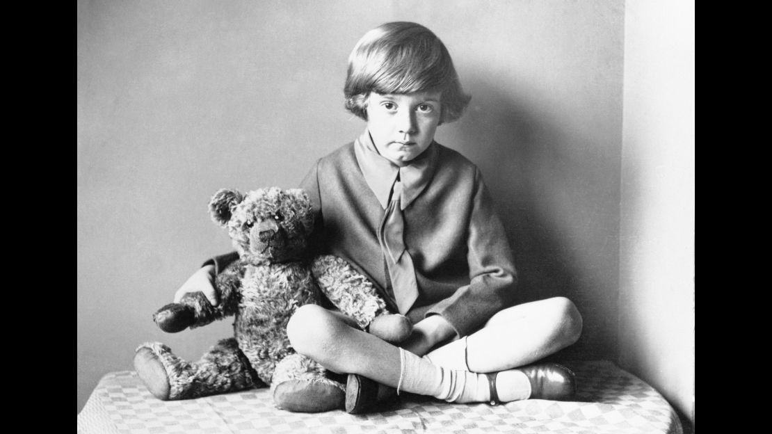 Author A.A. Milne's son, Christopher Robin sitting at home with the original Pooh Bear