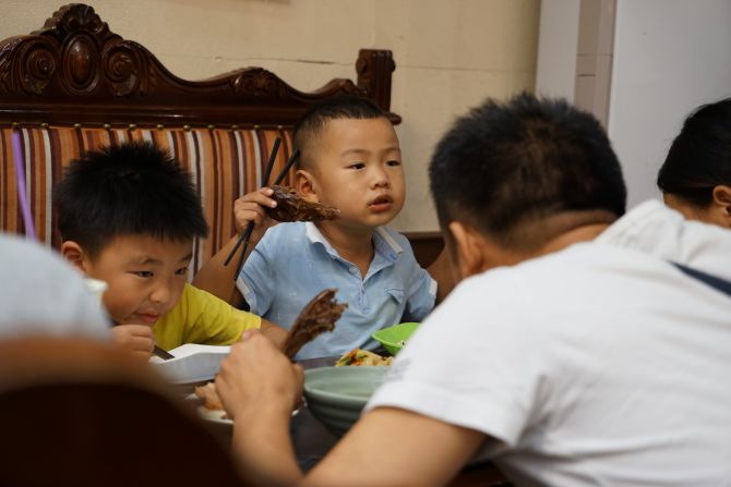 Nanjing's locals take duck fever to new levels. These kids are  chowing down on entire duck heads.