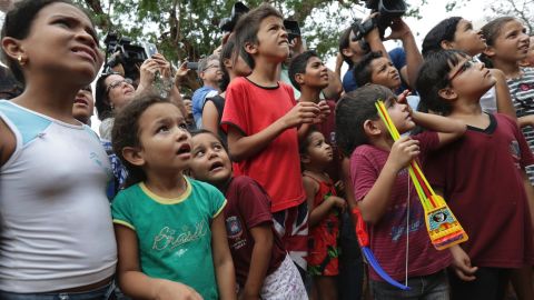 Children from the Rio da Casca community react to seeing an elephant for the first time on October 11 as they watch the convoy transporting Asian elephants Maia and Guida to their new home.