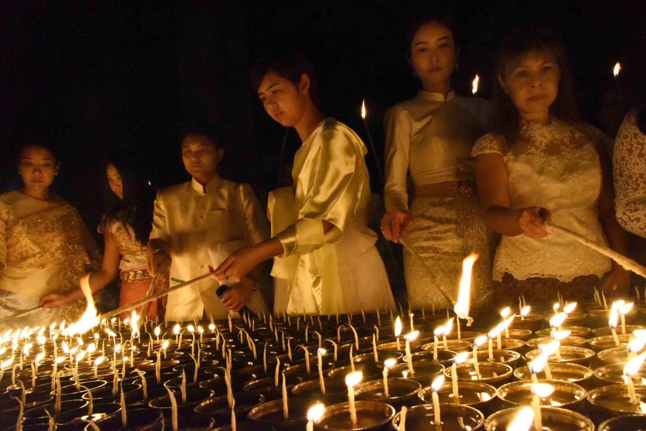 Devotees light candles for the late Thai King at Mahabodhi temple in Bodhgaya on October 14.