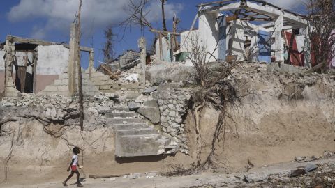 A girl walks by damage from Hurricane Matthew in Port Salut, Haiti, last week.