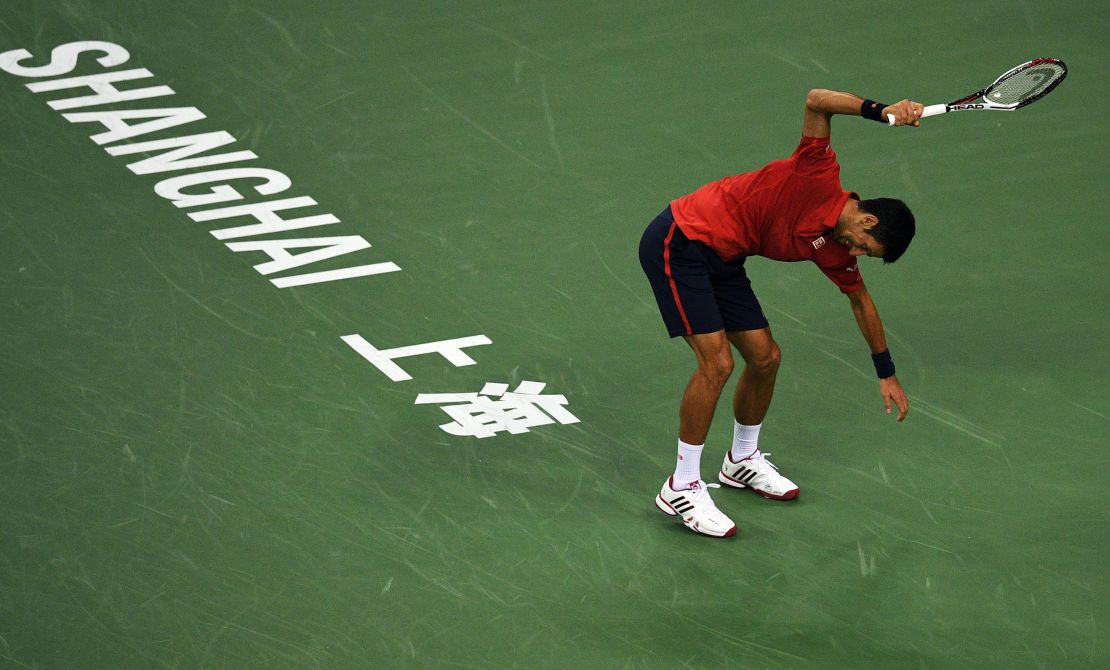 Djokovic smashes his racket after losing the first set.