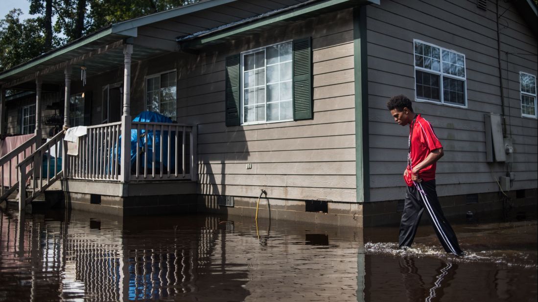 Jibrail Freeman walks to his flood-damaged home on Saturday, October 15, in Lumberton, North Carolina. A week after Hurricane Matthew hit North Carolina, flooding is still a major problem for residents. The storm caused 26 deaths in the state.