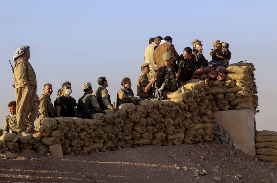 Peshmerga forces stand guard at Kargali village during an operation to liberate Mosul.