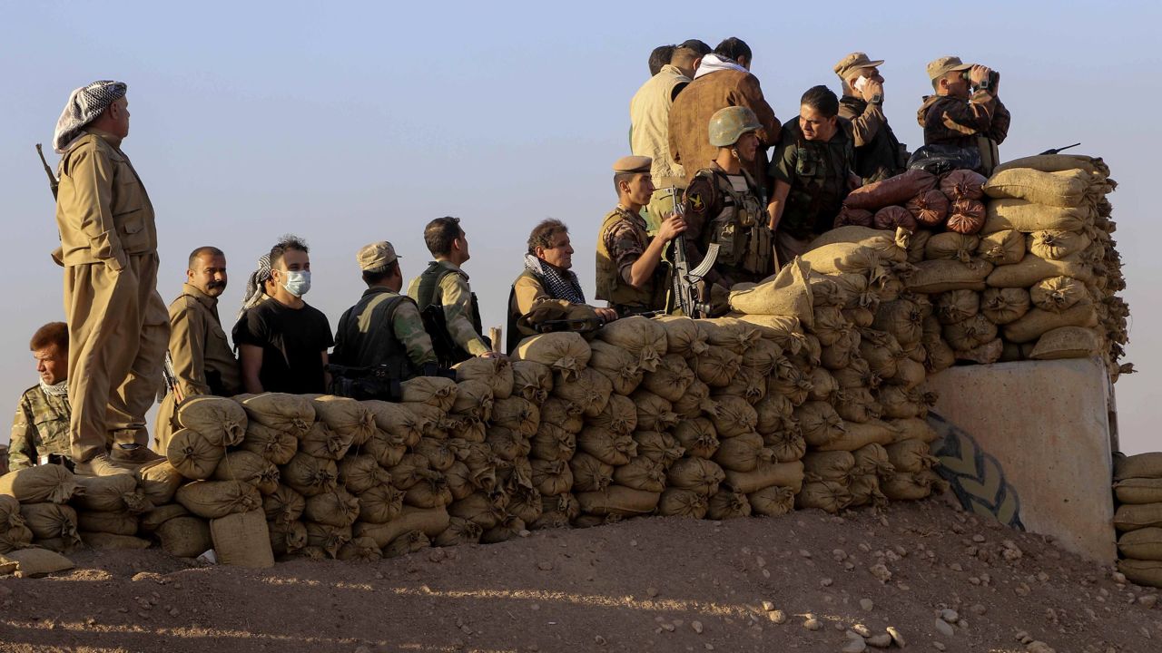 Peshmerga forces stand guard at Kargali village during an operation to liberate Mosul.