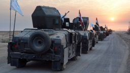Pro-government forces drive in military vehicles in Iraq's eastern Salaheddin province, south of Hawijah, on October 10, 2016, as they clear the area in preparation for the push to retake the northern Iraqi city of Mosul, the last Islamic State (IS) group held city in Iraq.  