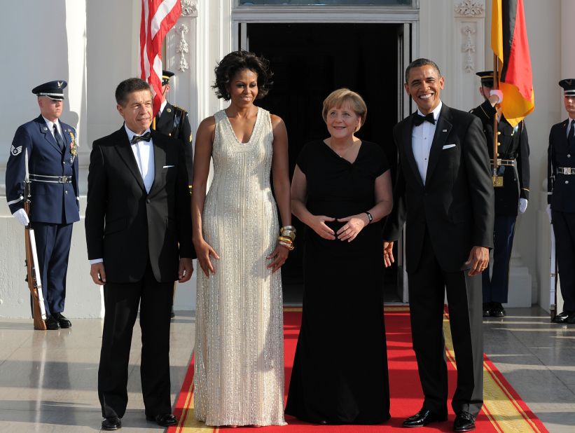 President Barack Obama and first lady Michelle Obama greet German Chancellor Angela Merkel and her husband Joachim Sauer at the White House on June 7, 2011, for their state dinner. 