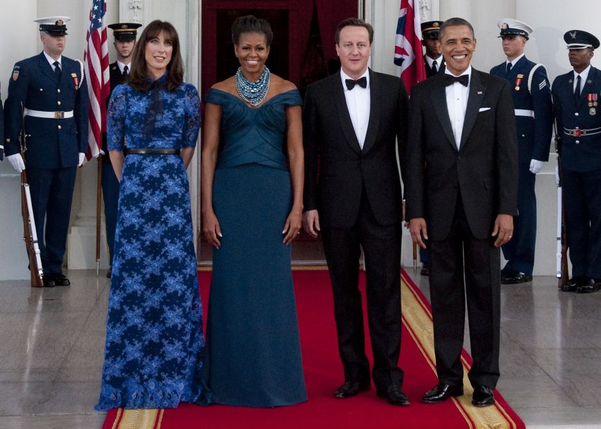 President Barack Obama and first lady Michelle Obama stand alongside British Prime Minister David Cameron and wife Samantha Cameron as they arrive for a state dinner at the White House on March 14, 2012. 