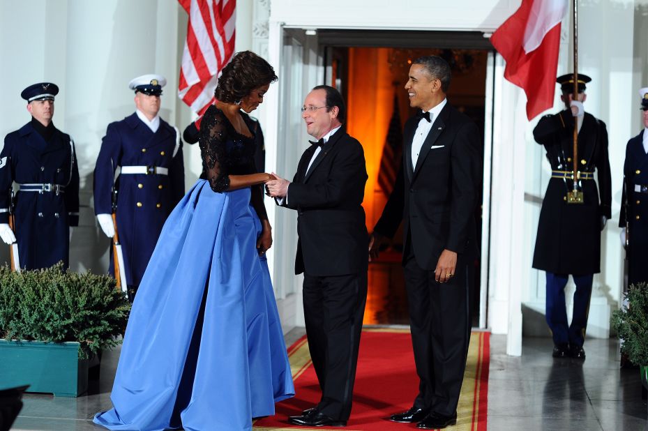 US President Barack Obama and first lady Michelle Obama welcome French President Francois Hollande as he arrives for a state dinner at the White House on February 11, 2014. 