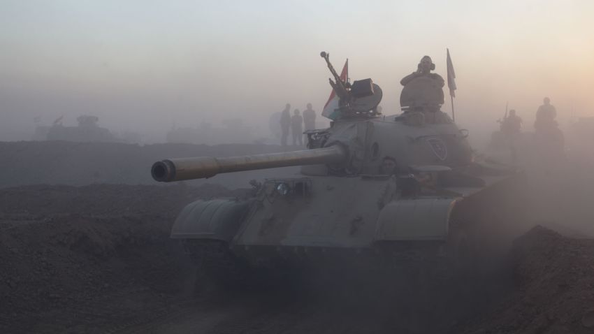 At the start of the operation to liberate Mosul from ISIS on Sunday, Oct 17th 2016. Dust and engine fumes fill the air as Kurdish Peshmerga forces use old soviet-era tanks and APCs to cross a berm into ISIS held territory in the Ninawa valley. (CREDIT: Ghazi Balkiz/CNN)
