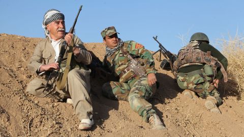 Kurdish fighters exchange fire with ISIS members in a village about 500 meters away on October 16, 2016.