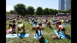 CHICAGO, IL - JULY 16:  Fitbit Local Ambassadors Jeremy Walton and Jenny Finkel lead participants in a bootcamp and yoga workout during the launch of Fitbit Local Free Community Workouts In Chicago at Grant Park on July 16, 2016 in Chicago, Illinois.  (Photo by Daniel Boczarski/Getty Images for Fitbit)