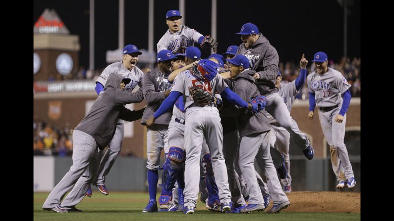 The Chicago Cubs celebrate around pitcher Aroldis Chapman after closing out their playoff series in San Francisco on Tuesday, October 11.