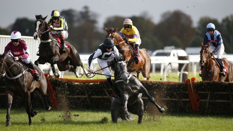 Gavin Sheehan and his horse, Masterson, fall during a hurdles race in Sunbury, England, on Sunday, October 16.