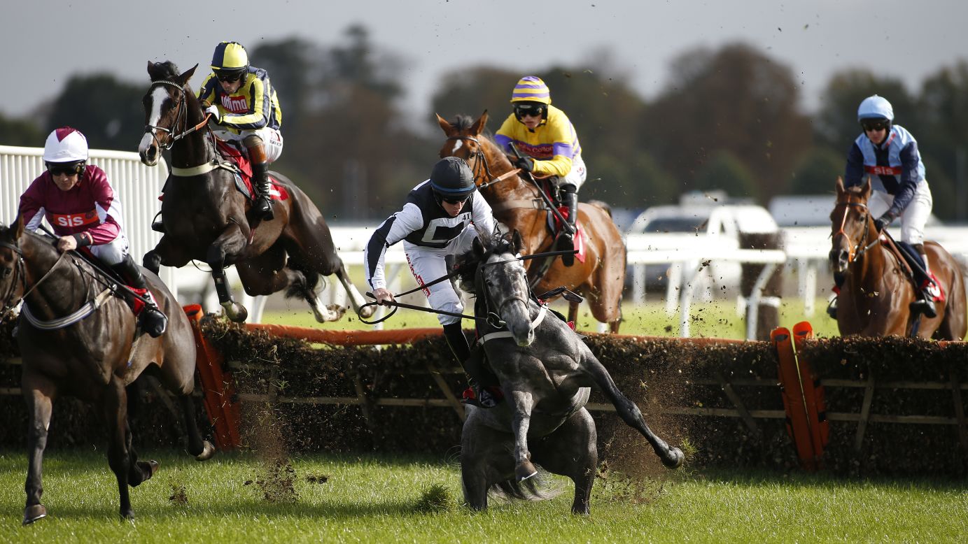 Gavin Sheehan and his horse, Masterson, fall during a hurdles race in Sunbury, England, on Sunday, October 16.