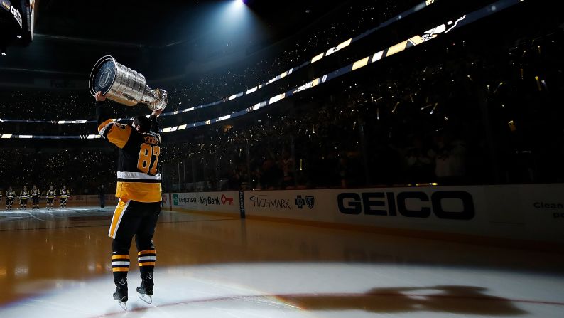Pittsburgh captain Sidney Crosby skates with the Stanley Cup during pregame ceremonies on Thursday, October 13. The Penguins were raising their championship banner before the first home game of the new season.