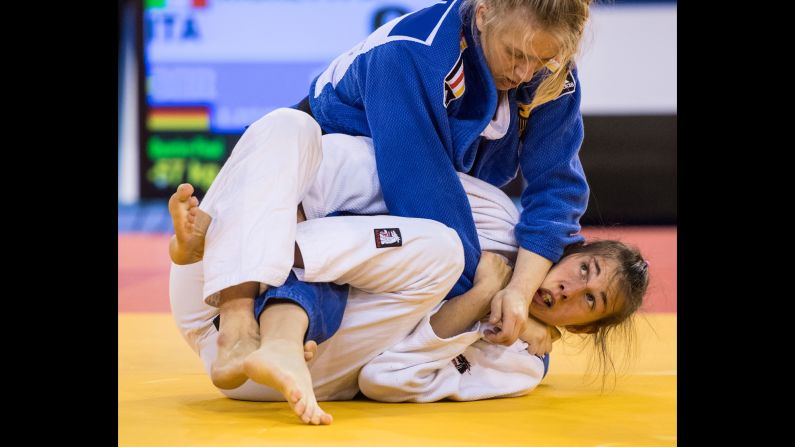 German judoka Jacqueline Lisson, in blue, tries to submit Italy's Anna Righetti during a tournament in Glasgow, Scotland, on Saturday, October 15.